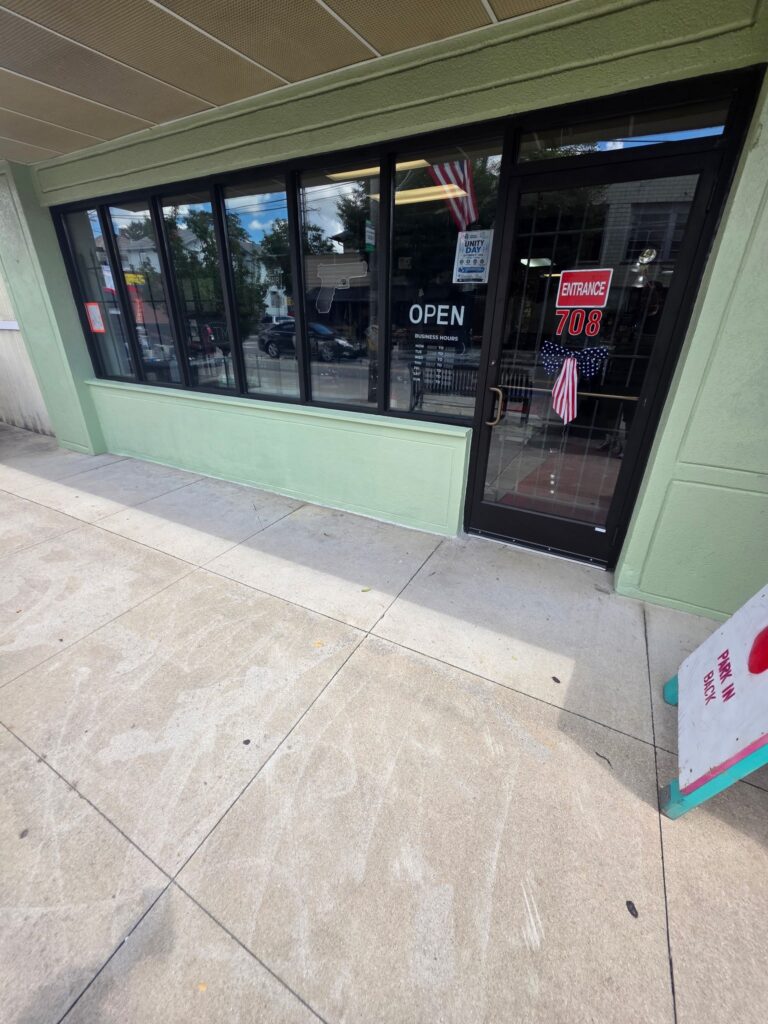 Finished glass entry door and black storefront frames at Rich's Pawn Shop in Dayton after the rebuild.
