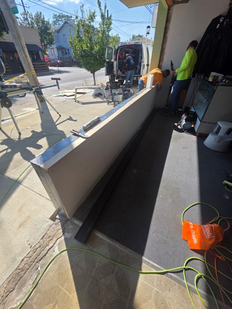 New knee wall framed and sheathed during a storefront rebuild at a Dayton pawn shop.
